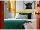 Bedroom with yellow headboard and green and gold accents at 2735 Calabria N Ave, Davenport, FL 33897