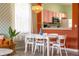 White dining table with six chairs, view into kitchen at 2735 Calabria N Ave, Davenport, FL 33897