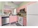Pink kitchen features stainless steel appliances and ample counter space at 2735 Calabria N Ave, Davenport, FL 33897