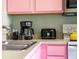 Pink kitchen counter with coffee maker, toaster, and kettle at 2735 Calabria N Ave, Davenport, FL 33897