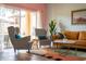 Living room with patterned armchairs and mustard sofa at 2735 Calabria N Ave, Davenport, FL 33897