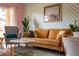 Living area with mustard couch, patterned chairs, and retro decor at 2735 Calabria N Ave, Davenport, FL 33897