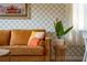 Mustard-colored sofa with colorful pillows in a retro-styled living room at 2735 Calabria N Ave, Davenport, FL 33897