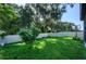 Fenced backyard with lush grass and a small tree at 2775 Red Horse Dr, Kissimmee, FL 34744