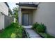 Gray front door with a walkway and landscaping at 2775 Red Horse Dr, Kissimmee, FL 34744