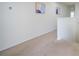 Upstairs hallway with neutral carpet and wall art at 2775 Red Horse Dr, Kissimmee, FL 34744