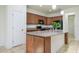 Kitchen with island, granite counters, and wood cabinets at 2775 Red Horse Dr, Kissimmee, FL 34744