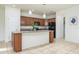 Kitchen with island, granite counters, and wood cabinets at 2775 Red Horse Dr, Kissimmee, FL 34744