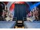 Bedroom with twin beds, Avengers mural, and dark blue curtains at 3083 Mahalo Dr, Davenport, FL 33897