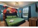 Bedroom with a king-size bed, parrot wall art, and plenty of natural light at 3083 Mahalo Dr, Davenport, FL 33897