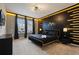 Elegant bedroom with a king-size bed, black and gold accents, and large windows at 3083 Mahalo Dr, Davenport, FL 33897
