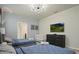 Bedroom with two twin beds, crib, TV, and access to bathroom at 3083 Mahalo Dr, Davenport, FL 33897