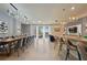 Spacious dining room with large table, modern lighting, and access to the living area at 3083 Mahalo Dr, Davenport, FL 33897