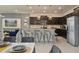 Modern kitchen with dark cabinets, granite counters, and stainless steel appliances at 3083 Mahalo Dr, Davenport, FL 33897