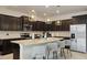 Modern kitchen with large island, dark cabinets, and stainless steel appliances at 3083 Mahalo Dr, Davenport, FL 33897