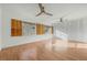 Spacious bedroom with light wood flooring, ceiling fan, and large windows at 3104 Harrison Ave # B9, Orlando, FL 32804