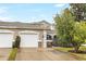 Two-story townhome with attached two-car garage and driveway at 3237 River Branch, Kissimmee, FL 34741