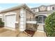 Tan two-story townhome with white garage door and landscaping at 3237 River Branch, Kissimmee, FL 34741