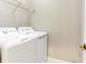 Laundry room with white washer and dryer, and shelving at 3237 River Branch, Kissimmee, FL 34741