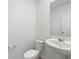 Simple white bathroom with pedestal sink and toilet at 5305 Maddie Dr, Haines City, FL 33844