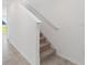 Carpeted staircase with white railings and tile flooring at 5305 Maddie Dr, Haines City, FL 33844