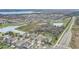 Aerial view showcasing a community with houses, roads, and a lake at 5530 Cypress Hill Rd, Winter Garden, FL 34787