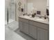 Spa-like bathroom with double vanity, granite countertop and a large walk-in shower at 5590 Stockade Blvd, St Cloud, FL 34771