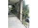 Balcony with railing overlooking trees and parking at 6039 Village Cir # Bldg C, Orlando, FL 32822