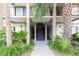 Condo building entrance with stairs and landscaping at 6039 Village Cir # Bldg C, Orlando, FL 32822