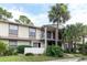 Condo building exterior with palm trees and landscaping at 6039 Village Cir # Bldg C, Orlando, FL 32822