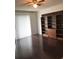 Living room with dark hardwood floors and built-in shelving at 6039 Village Cir # Bldg C, Orlando, FL 32822