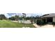 Refreshing community pool with lounge chairs and green space at 6039 Village Cir # Bldg C, Orlando, FL 32822