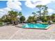 Community pool with brick patio and tropical landscaping at 6039 Village Cir # Bldg C, Orlando, FL 32822