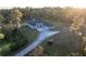 Aerial view of a house with a three-car garage and long driveway at 720 Napoli Ln, New Smyrna Beach, FL 32168