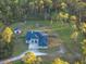 House with detached shed, large backyard, and surrounding trees at 720 Napoli Ln, New Smyrna Beach, FL 32168