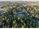 Aerial view showcasing a house nestled in a wooded area with a long driveway at 720 Napoli Ln, New Smyrna Beach, FL 32168