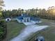 Aerial view of a house with a three-car garage, large yard, and outbuildings at 720 Napoli Ln, New Smyrna Beach, FL 32168