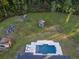 Aerial view of a home with a pool and expansive backyard, plus garden and outbuildings at 720 Napoli Ln, New Smyrna Beach, FL 32168