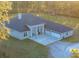 An aerial view of a house with a three-car garage and a large yard at 720 Napoli Ln, New Smyrna Beach, FL 32168