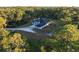 Aerial view of a house on a large lot with surrounding trees at 720 Napoli Ln, New Smyrna Beach, FL 32168