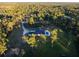 Aerial view of a home with a pool and large backyard in a wooded area at 720 Napoli Ln, New Smyrna Beach, FL 32168