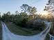 Aerial view of a home with a long driveway and surrounding trees at 720 Napoli Ln, New Smyrna Beach, FL 32168