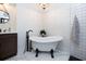 Elegant bathroom with freestanding bathtub, marble flooring, and modern fixtures at 720 Napoli Ln, New Smyrna Beach, FL 32168