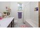 Charming bathroom with white subway tile, a shower/tub combo, and hexagon flooring at 720 Napoli Ln, New Smyrna Beach, FL 32168