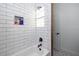 Clean bathroom with subway tile, a bathtub, and hexagon floor tile at 720 Napoli Ln, New Smyrna Beach, FL 32168