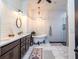 Spa-like bathroom featuring a soaking tub, walk-in shower, and double vanity at 720 Napoli Ln, New Smyrna Beach, FL 32168