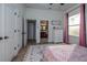 Bright bedroom with a queen bed, ensuite bathroom access, and large windows at 720 Napoli Ln, New Smyrna Beach, FL 32168