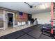 Large garage with home office area, American flag, and plenty of storage at 720 Napoli Ln, New Smyrna Beach, FL 32168