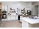 White kitchen with shiplap accent wall and floating shelves at 720 Napoli Ln, New Smyrna Beach, FL 32168