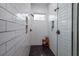 Spa-like shower with subway tile, built-in shelving, and pebble floor at 720 Napoli Ln, New Smyrna Beach, FL 32168